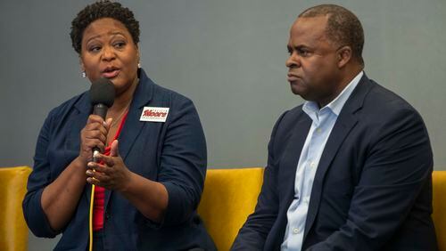 Atlanta mayoral candidate Kasim Reed listens as candidate Felicia Moore speaks during a forum hosted by Partners for HOME and Policing Alternatives & Diversion Initiative at the Institute of Technology Hotel and Conference Center in Atlanta on October 1, 2021. (Alyssa Pointer/Atlanta Journal Constitution)