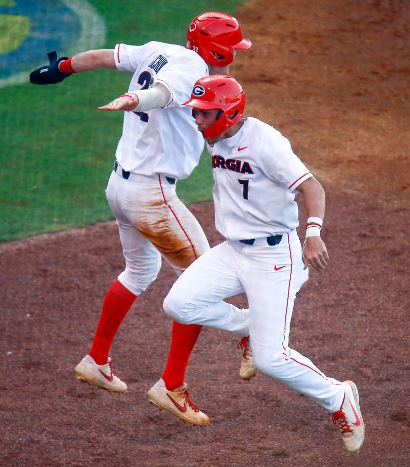 Georgia's Cam Shepherd (7) and Aaron Schunk (22) celebrate after scoring the go ahead runs on a double by Patrick Sullivan during the eighth inning of the team's Southeastern Conference tournament NCAA college baseball game against Arkansas, Thursday, May 23, 2019, in Hoover, Ala. (AP Photo/Butch Dill)