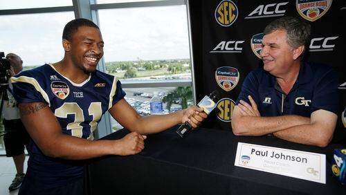 Georgia Tech running back Deon Hill, left, laughs after head coach Paul Johnson answered his question during media day, Monday, Dec. 29, 2014, in Miami Gardens, Fla. Georgia Tech will play Mississippi State in the Orange Bowl NCAA college football game on New Year's Eve. (AP Photo/Wilfredo Lee). Georgia Tech A-back Deon Hill demands answers from coach Paul Johnson during the team's media day appearance at Sun Life Stadium. (ASSOCIATED PRESS)
