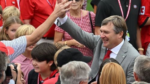 Georgia's head coach Kirby Smart is surrounded by fans as players and coaching staff participate in the Dawg Walk before their game against South Carolina in an NCAA football game at Sanford Stadium, Saturday, September 16, 2023, in Athens. (Hyosub Shin / Hyosub.Shin@ajc.com)