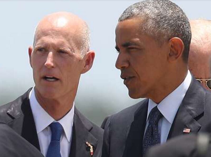 Florida Gov. Rick Scott looks on as President Barack Obama and Sen. Marco Rubio (R-FL) arrive at the Orlando International Airport to visit with family and community members after the attack at the Pulse gay nightclub where Omar Mateen killed 49 people on June 16, 2016 in Orlando, Florida. The mass shooting on June 12th killed 49 people and injured 53 others in what is the deadliest mass shooting in the country's history. (Photo by Joe Raedle/Getty Images)