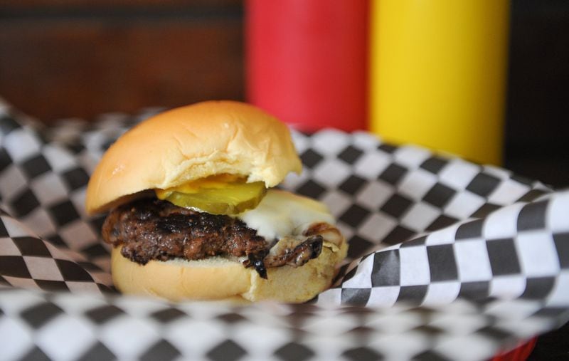 Single cheese --  a 2 oz patty, ground fresh in house, served with American cheese, grilled onions, mustard and pickles -- at Little’s Food Store in Cabbagetown. (BECKY STEIN PHOTOGRAPHY.COM)