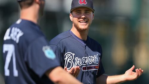 Braves pitcher Jacob Lindgren shares a laugh with Adam Kolarek while loosening up for practice during spring training at Champion Stadium on Sunday Feb. 19, 2017, at the ESPN Wide World of Sports in Lake Buena Vista, Fla.   Curtis Compton/ccompton@ajc.com