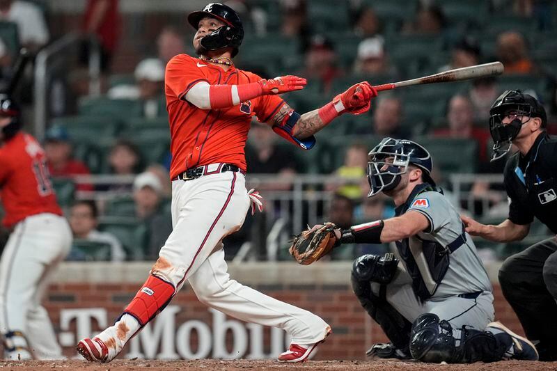 Atlanta Braves shortstop Orlando Arcia (11) hits solo homer against the Cleveland Guardians during the eighth inning of a baseball game, Friday, April 26, 2024, in Atlanta. (AP Photo/Mike Stewart)