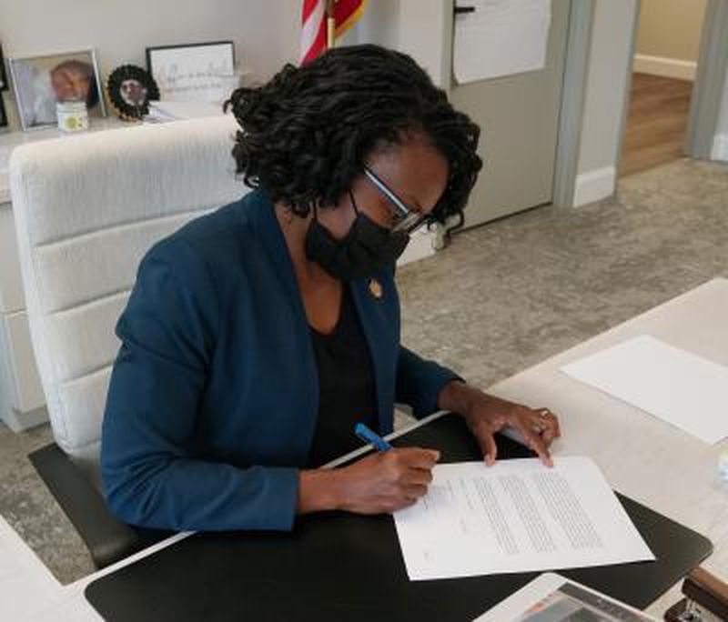 Cobb County Chairwoman Lisa Cupid signs an order declaring the county in a State of Emergency due to the latest surge in COVID-19 cases on Thursday, Aug. 19, 2021. (Photo courtesy of Cobb County)