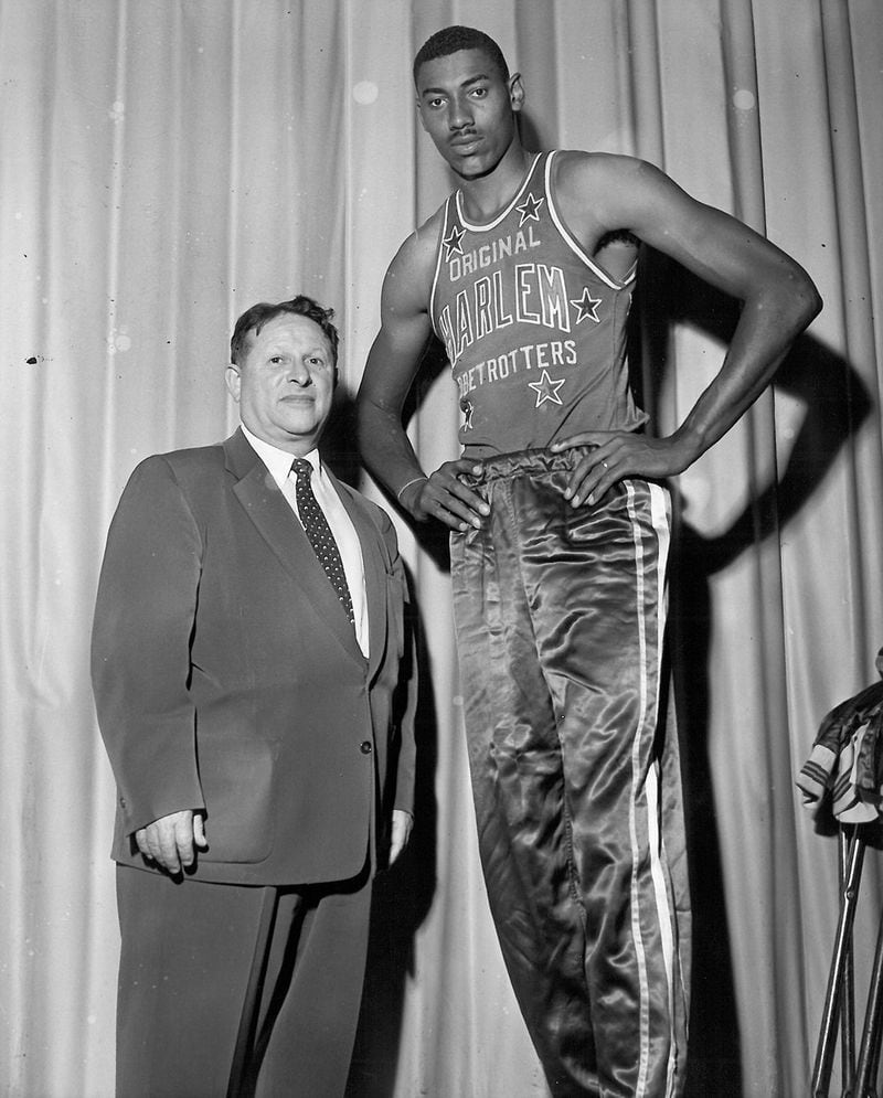 NBA star Wilt Chamberlain, right, was a member of the Harlem Globetrotters for its 1958-59 season. Chamberlain, seen here with Globetrotters owner Abe Saperstein, joined the team when the NBA forced him to wait a year before allowing him to join an NBA team. (Courtesy of the Harlem Globetrotters)