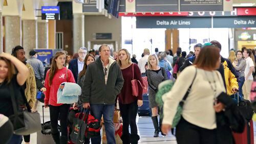 Nov. 20, 2015 - Atlanta - Travelers walk toward baggage claim at the airport. Record crowds are expected along with long lines and delays at Hartsfield-Jackson Atlanta International Airport, the world's busiest airport, which is forecasting some of the biggest increases in traffic it has seen in years. BOB ANDRES / BANDRES@AJC.COM