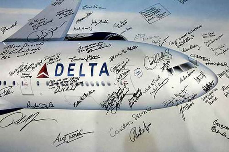 The signatures of Delta employees and other well-wishers are shown on a banner at the delivery ceremony for the new Boeing 777-200LR.