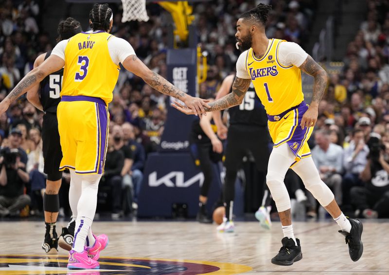 Los Angeles Lakers guard D'Angelo Russell (1) celebrates after a 3-point basket with teammate forward Anthony Davis (3) during the first half against the Denver Nuggets in Game 2 of an NBA basketball first-round playoff series Monday, April 22, 2024, in Denver. (AP Photo/Jack Dempsey)