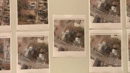Aerial photos of properties that Atlanta Public Schools seeks to acquire through eminent domain are displayed during a school board meeting on Aug. 6.