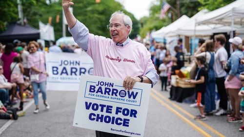 During an Atlanta festival parade in late April, Georgia Supreme Court candidate John Barrow donned a pink t-shirt emblazoned with the words “Empowering Women” and carried a “Vote For Choice” campaign sign. He doubled down on his abortion rights message a few days later during an Atlanta Press Club candidate debate, when he criticized his opponent, Justice Andrew Pinson, for defending Georgia’s anti-abortion law. (Elijah Nouvelage for The Atlanta Journal-Constitution)