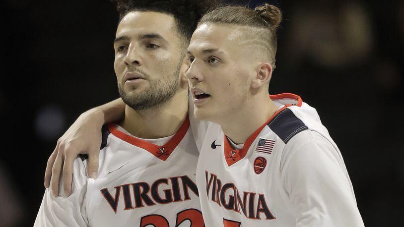 Virginia guard London Perrantes (32) and guard Kyle Guy (5) walk off the court during a timeout in the second half of the team’s NCAA college basketball game against Pittsburgh in the second round of the Atlantic Coast Conference tournament, Wednesday, March 8, 2017, in New York. Virginia won 75-63. (AP Photo/Julie Jacobson)
