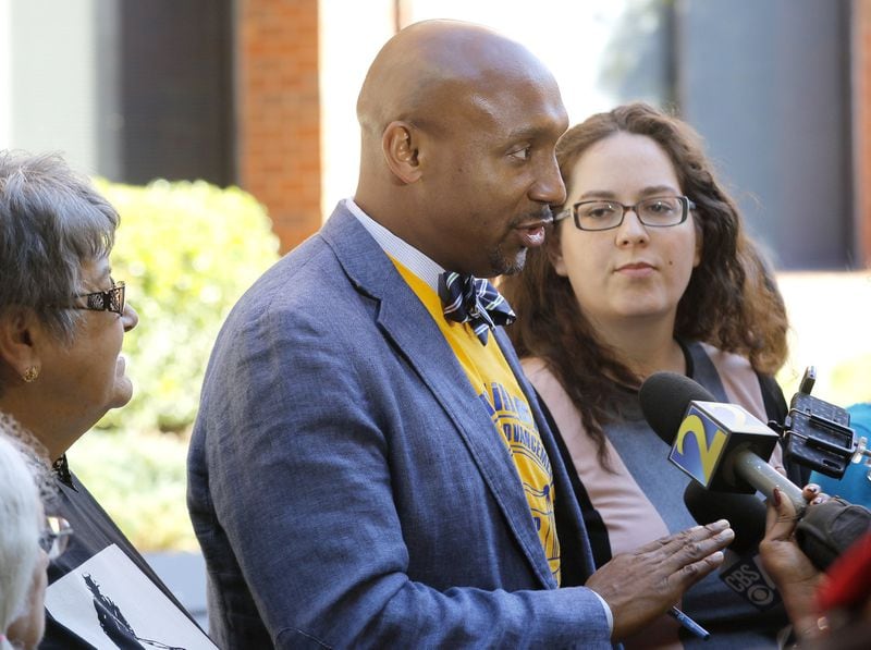 Mawuli Davis (left), president of the Beacon Hill NAACP, and Sara Patenaude, co-founder of Hate Free Decatur, speak to the media after supporting the removal of a Confederate monument from Decatur during public comments to the DeKalb Board of Commissioners meeting Tuesday, Oct. 24, 2017. BOB ANDRES /BANDRES@AJC.COM