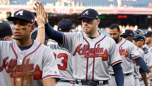 Braves' Freddie Freeman celebrates a win with teammates after a baseball game against the Washington Nationals at Nationals Park on July 8, 2017, in Washington, DC.