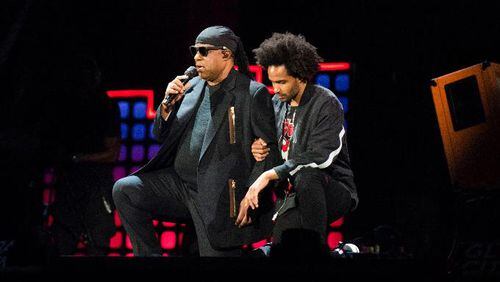Stevie Wonder, left, takes a knee "for the country" with his son, Kwame Morris, before performing at the 2017 Global Citizen Festival in Central Park, Saturday, Sept. 23, 2017, in New York. The festival aims to end extreme poverty through the collective actions of Global Citizens by 2030.  (AP Photo/Michael Noble Jr.)