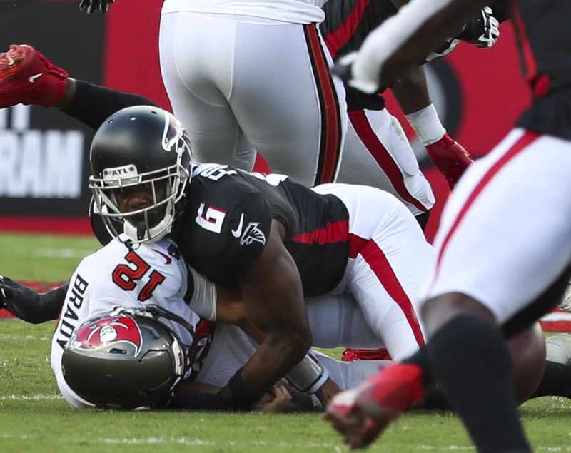 Tampa Bay Buccaneers quarterback Tom Brady (12) is sacked by Falcons defensive end Dante Fowler Jr. (6) as he fumbles the ball during the first half  Sunday, Sept. 19, 2021, at Raymond James Stadium in Tampa. (Dirk Shadd/Tampa Bay Times)