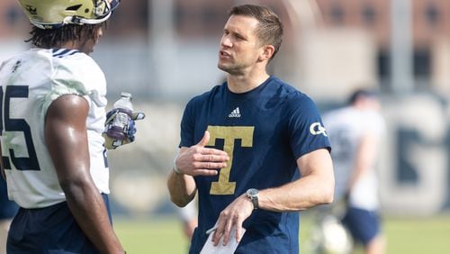 Defensive coordinator Andrew Thacker talks with Charlie Thomas (25) during the first day of spring practice for Georgia Tech football at Alexander Rose Bowl Field in Atlanta, GA., on Thursday, February 24, 2022. (Photo Jenn Finch)
