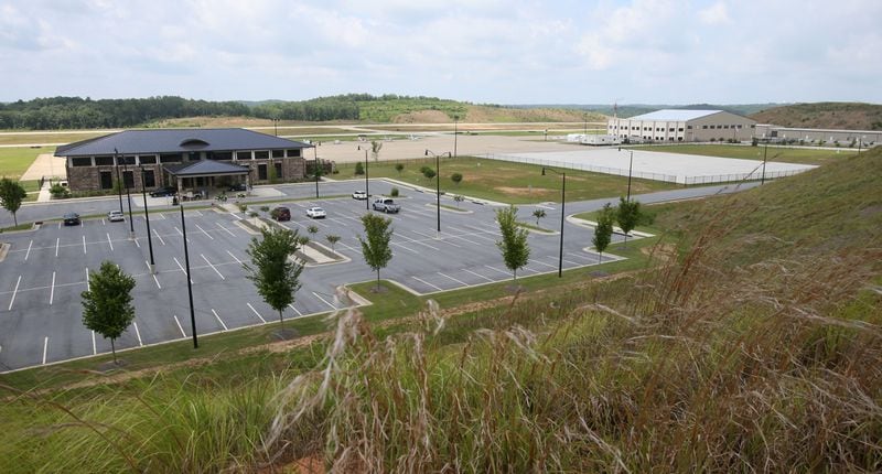 June 25, 2014 - Paulding County - The Paulding County Airport terminal (left) and new hangers (right) viewed from a hill overlooking the airport. Taxi way expansion has been completed, and construction continues in FBO area of Paulding County Airport. First, Delta CEO Richard Anderson said he would fight Paulding County's effort to commercialize its airport. Then residents filed four legal challenges. Now, the city of Atlanta is threatening legal action, saying Paulding, which purchased land from Atlanta for the airport back in 2007, is in breach of contract on that deal. Paulding officials deny that and say Atlanta's opposition flies in the face of the regionalism that Mayor Kasim Reed spoke about to leaders there a few years ago. BOB ANDRES / BANDRES@AJC.COM