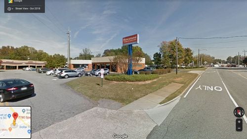 A Firestone auto services center at 7780 Spalding Drive, Sandy Springs, is one of five parcels facing eminent domain action by the city, which is seeking portions of their land for a sidewalk project. GOOGLE MAPS