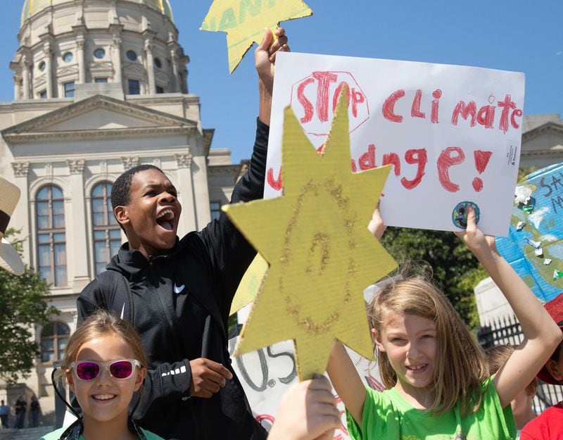 Jordan Madden (L) from Moutzion High School cheers near the Georgia Capitol during the Climate Reality Strike March Friday, September 20, 2019.  