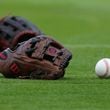 042821 Atlanta: Atlanta Braves shortstop Dansby Swanson’s glove and ball sit on the field while preparing to play the Chicago Cubs in a MLB baseball game on Wednesday, April 28, 2021, in Atlanta.    “Curtis Compton / Curtis.Compton@ajc.com”