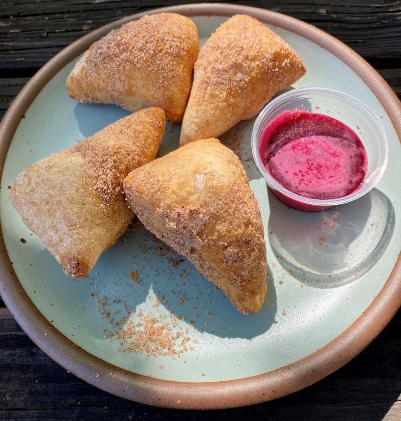 Dolos Pizza’s Sweet Dolitas are a puffy doughnut-like confection of sweet fried dough, coated in cinnamon-sugar and served with hibiscus icing. Wendell Brock for The Atlanta Journal-Constitution