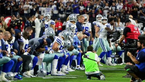 Jerry Jones and his Dallas Cowboys kneel on the field prior to the national anthem on Monday night.