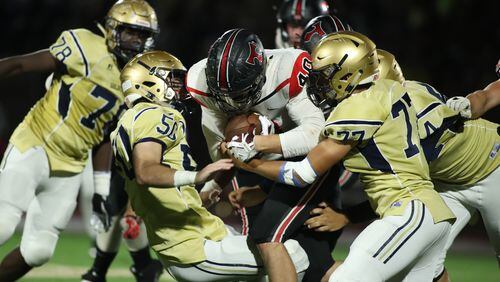 October 12, 2018 - Atlanta: North Oconee running back Adam Weyland (40) fights for yards against St. Pius defenders in the second half Friday, October 12, 2018, in Atlanta. St. Pius won 31-21. (JASON GETZ/SPECIAL TO THE AJC)
