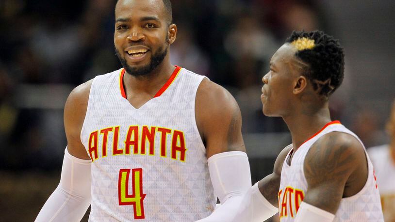 Atlanta Hawks forward Paul Millsap (4) and guard Dennis Schroder (17) reacts after Milsap scored late in the second half of an NBA basketball game between the Detroit Pistons and Atlanta Hawks on Friday, Dec. 30, 2016, in Atlanta. The Hawks won the game 105-98. (AP Photo/Todd Kirkland)