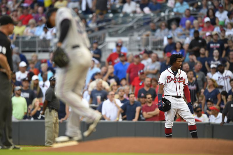 Braves' Ronald Acuna Jr. stands at first base after being hit by a pitch thrown by Miami Marlins' Elieser Hernandez. (AP Photo/John Amis)