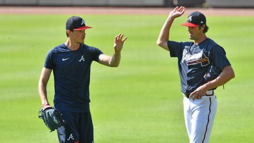 Braves pitchers Max Fried (left) and Cole Hamels talk during a workout in early July.