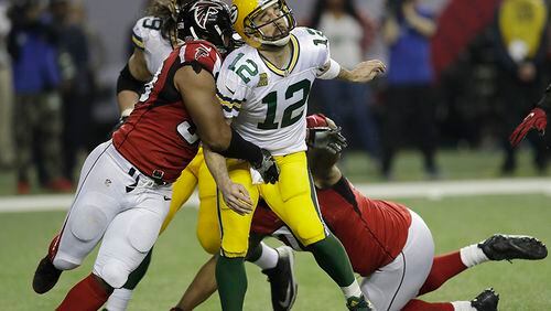 Atlanta Falcons defensive end Dwight Freeney (93) hits Green Bay Packers’ Aaron Rodgers after he throws during the second half of the NFL football NFC championship game Sunday, Jan. 22, 2017, in Atlanta. (AP Photo/David J. Phillip)