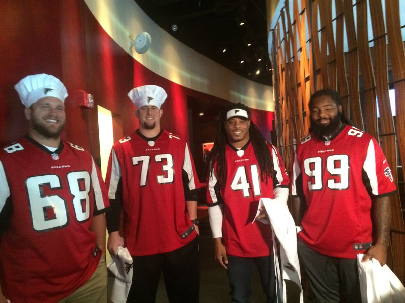 On Oct. 4, Atlanta Falcons players (from left) Mike Person, Ryan Schraeder, Philip Wheeler and Adrian Clayborn participated in a cook-off with culinary students.