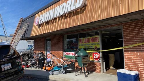 Police say the owner of Pawn World and his employee allegedly ran a fencing operation that sold stolen goods at their business. Credit: Marietta Police Department