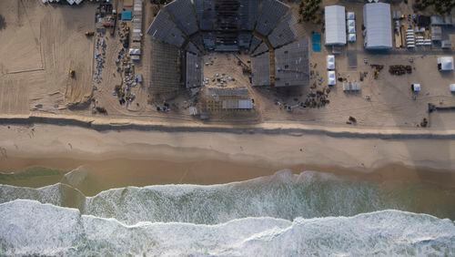 In this June 26, 2016, photo, the Olympic beach volleyball venue sits still under construction at Copacabana in Rio de Janeiro, Brazil.