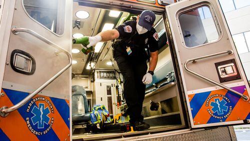 Jacob Palmer, an EMT with Habersham County Emergency Services, sanitizes an ambulance after dropping a patient in the emergency department at Northeast Georgia Medical Center. (Jenni Girtman for The Atlanta Journal Constitution)