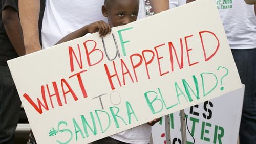William Mitchell, 5, of Houston, holds a sign at a rally at the Waller County Jail in Hempstead on Friday to protest the death of Sandra Bland, who was found dead in the jail.
