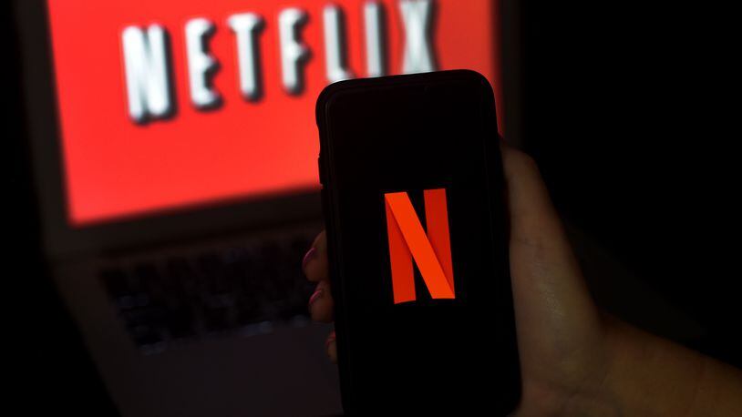 In this photo illustration a computer screen and mobile phone display the Netflix logo on March 31, 2020 in Arlington, Virginia. (Olivier Douliery/AFP/Getty Images/TNS)
