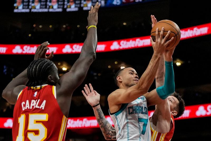Charlotte Hornets guard Bryce McGowens (7) moves to the basket against Atlanta Hawks center Clint Capela (15) during the first half of an NBA basketball game, Wednesday, April 10, 2024, in Atlanta. (AP Photo/Mike Stewart)