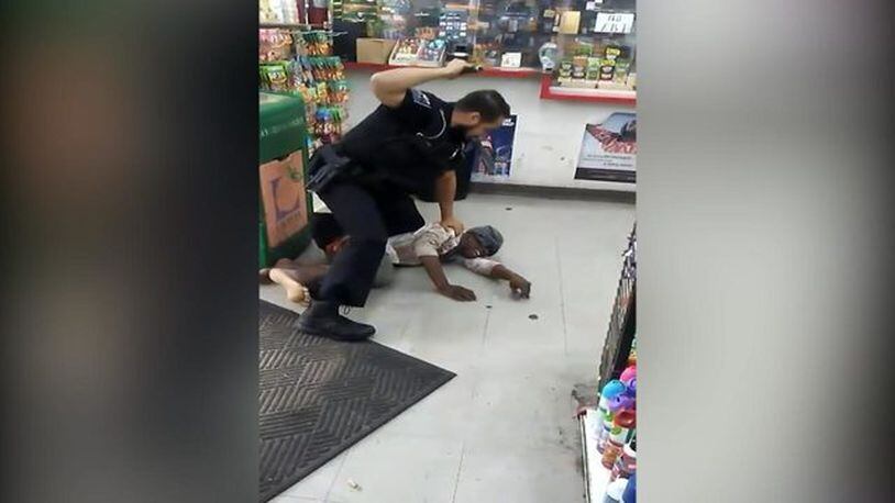 A video posted on YouTube shows the arrest and beating of a DeKalb County woman. (Credit: YouTube)