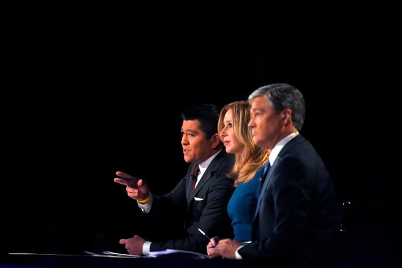 Debate moderators Carl Quintanilla, left, Becky Quick, center, and John Harwood appear during the CNBC Republican presidential debate at the University of Colorado, Wednesday, Oct. 28, 2015, in Boulder, Colo. (AP Photo/Mark J. Terrill)