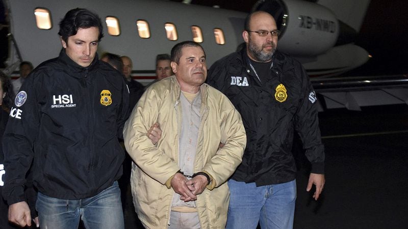 In this Jan. 19, 2017, file photo provided by U.S. law enforcement, authorities escort Joaquin "El Chapo" Guzman, center, from a plane to a waiting caravan of SUVs at Long Island MacArthur Airport, in Ronkonkoma, New York. An appeals court should overturn the U.S. conspiracy conviction of Guzman because of claims that his anonymous jury flouted warnings to avoid media accounts of the case, a lawyer for Guzman urged a three-judge panel Monday, catching the attention of at least one judge.