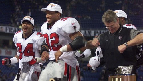 Falcons coach Dan Reeves (right) does the Dirty Bird dance with players Jamal Anderson (32) and Ray Buchanan (34) in 1999. (AJC file photo)