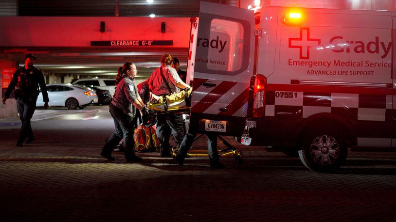 Grady Memorial Hospital paramedics load a gunshot victim into an ambulance Thursday outside the Camden Vantage Apartments on Jackson Street. The man was shot multiple times, according to Atlanta police.