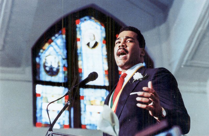 April 4, 1989 - Atlanta, Ga.: Dexter King takes to the podium at Ebenezer Baptist Church as the image of his grandfather, Daddy King, reflects off the stained glass window. Dexter was bestowed the presidency of the MLK Jr. Center for Social Change. (W. A. Bridges Jr/AJC staff) 1989