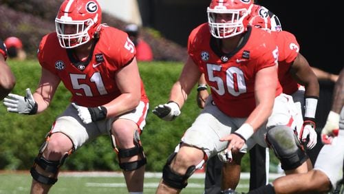 Georgia offensive lineman Tate Ratledge (51), and Warren Ericson (50) were working side--by-side with the No. 1 offense in the G-Day game last April. Now Ratledge is out with a foot injury and Ericson has taken over at right guard while still healing with a broken left hand.  (Photo by Rob Davis/UGA Athletics)