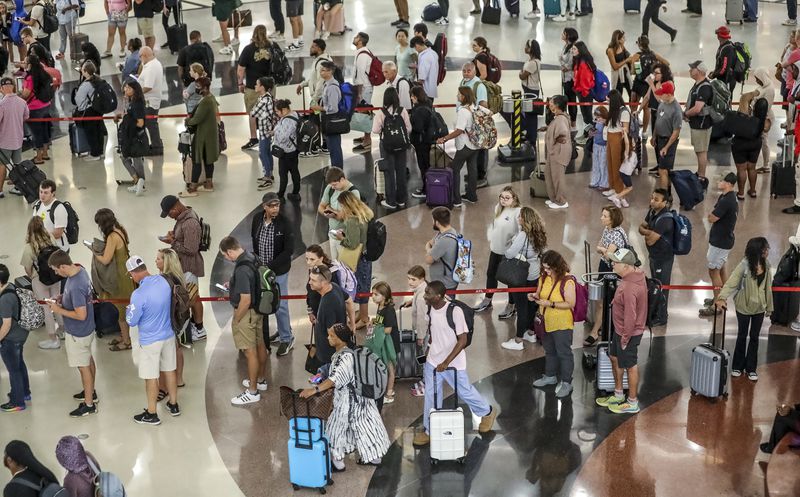 September 1, 2023 Atlanta: Hartsfield-Jackson International Airport’s domestic atrium was full of long lines of travelers waiting to go through security on Friday, Sept. 1, 2023. (John Spink / John.Spink@ajc.com)

