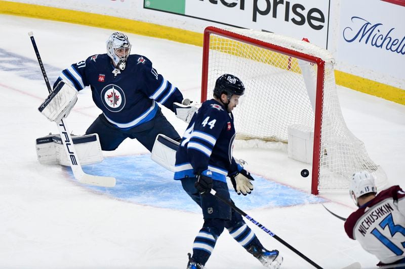 Colorado Avalanche Valeri Nichushkin (13) scores on Winnipeg Jets goaltender Connor Hellebuyck (37) during the first period in Game 5 of an NHL hockey Stanley Cup first-round playoff series in Winnipeg, Manitoba, Tuesday April 30, 2024. (Fred Greenslade/The Canadian Press via AP)
