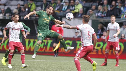 Portland’s Sebastian Blanco, center, tries to corral the ball as Atlanata’s Leandro Gonz’lez Pirez (5) defends as the Portland Timbers hosted Atlanta United FC in a MLS match at in Portland, Ore., Sunday, May 14, 2017. (Sean Meagher/The Oregonian via AP)