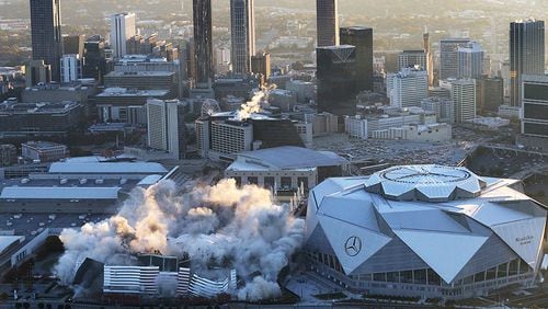 Mercedes-Benz Stadium, shown during the implosion of the Georgia Dome on Nov. 20, will host the College Football Playoff’s national championship game Jan. 8.
